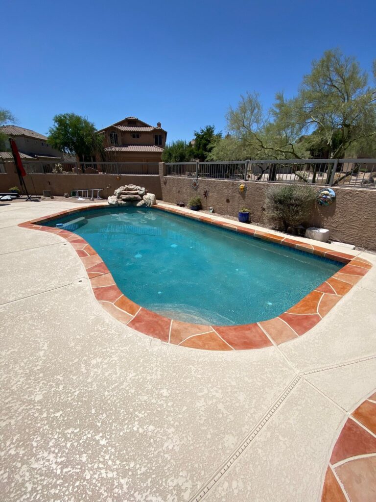 Backyard pool before resurfacing showing aging plaster and faded tile