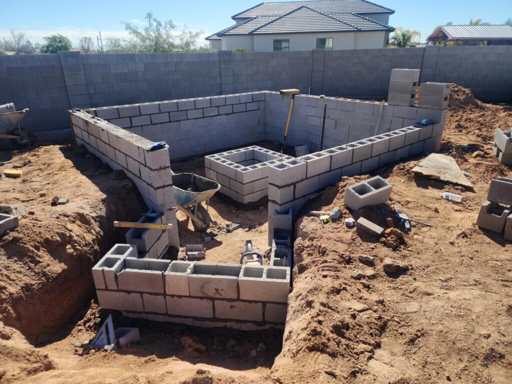 Block construction of backyard fire pit and seating area in Mesa