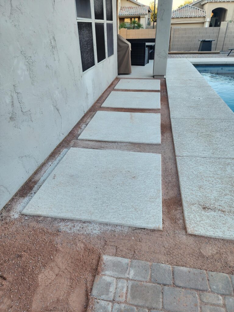 Stepping stone patio installation next to pool area
