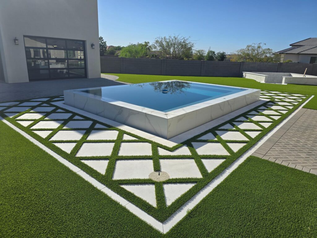 Elevated modern pool with white tile and diamond turf pattern