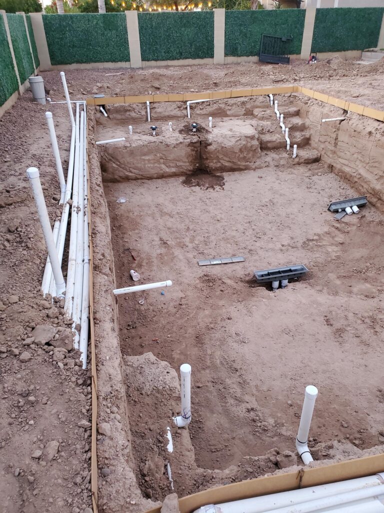Pool plumbing and excavation during new pool construction