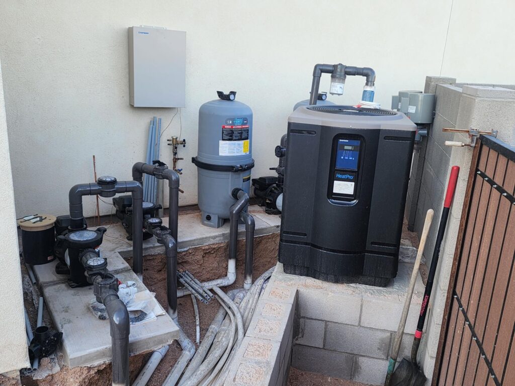 Pool equipment pad with heater, pumps, and filter system installed