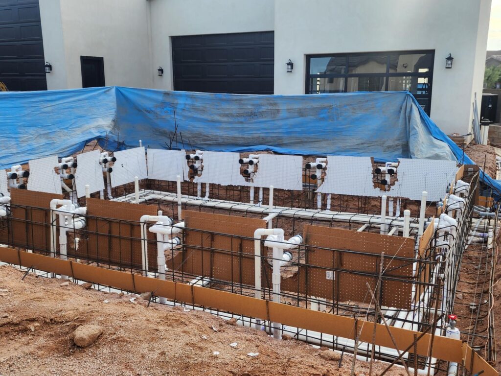 Detailed pool plumbing and rebar framework before concrete pour