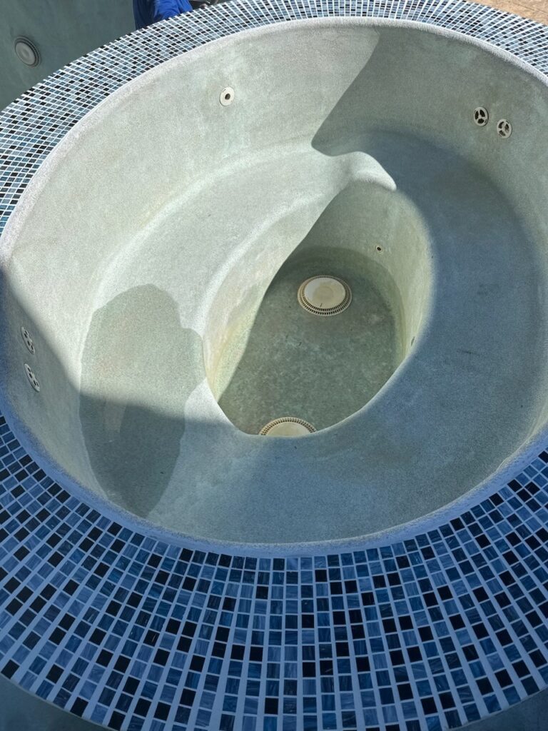 Close-up of spa installation with blue tile and plaster finish at Mesa pool project