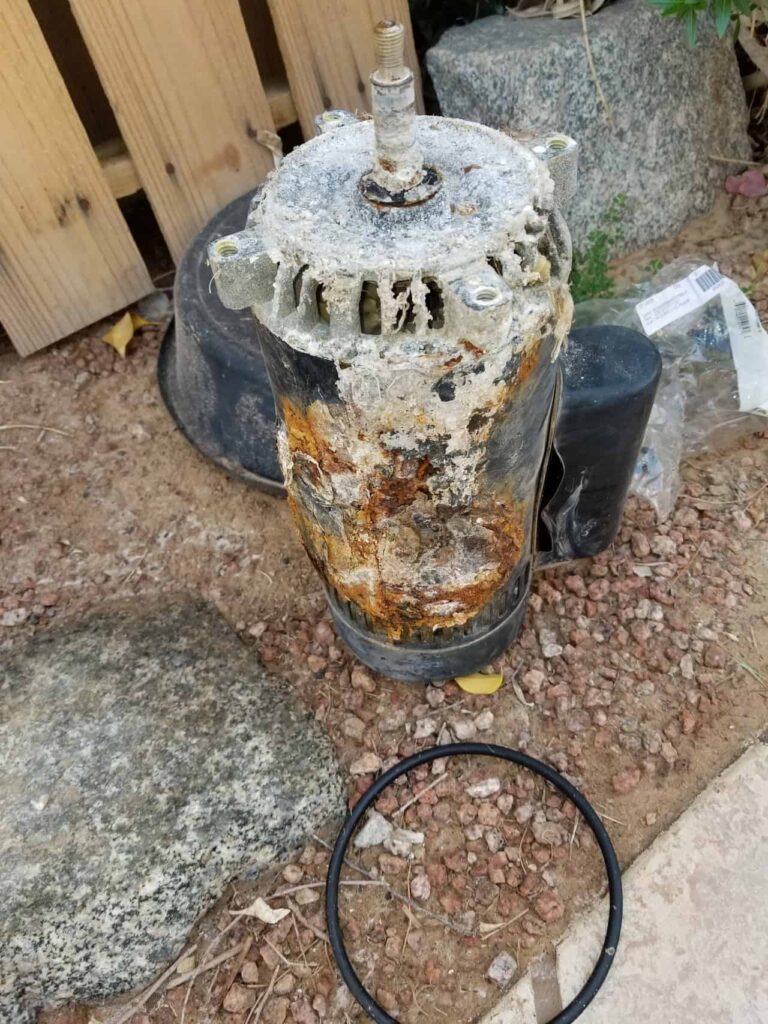 Corroded pool pump motor removed for replacement