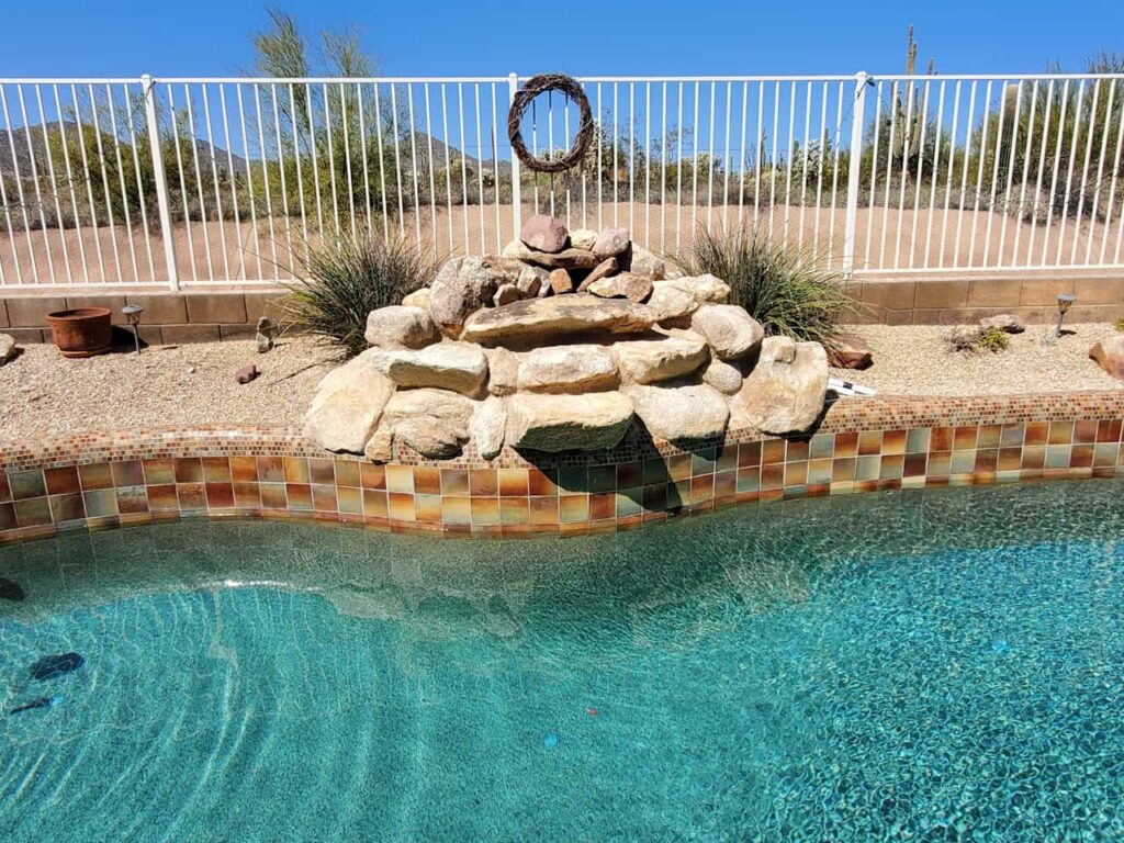 pool rock waterfall and tile detail