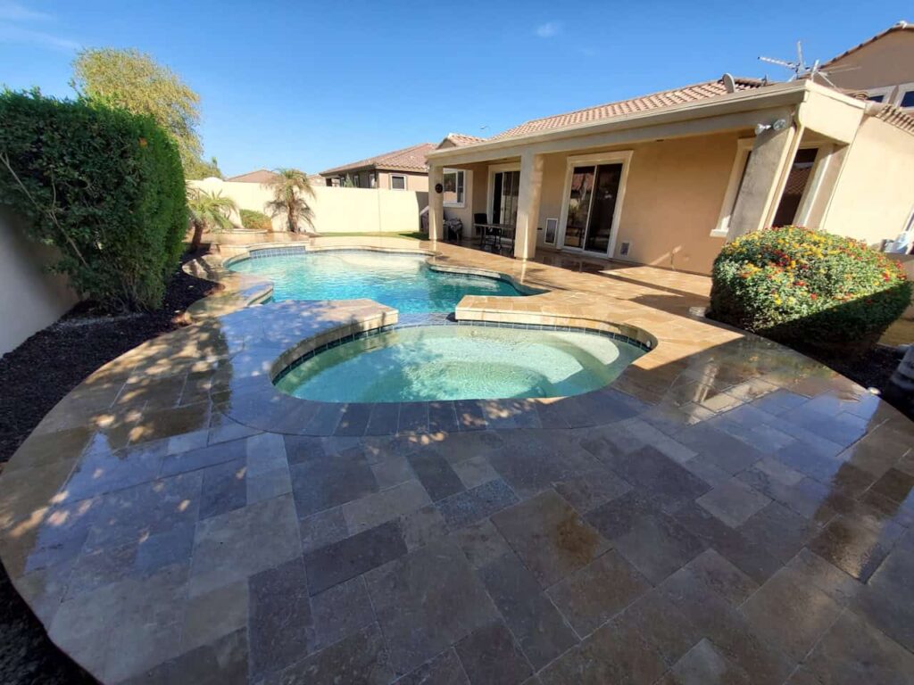 backyard pool and spa with clear water and routine maintenance